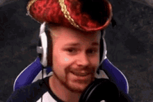 a man with a beard is wearing headphones and a pirate hat .