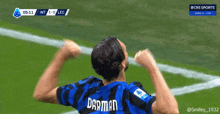 a soccer player wearing a darman jersey celebrates on the field
