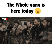 a group of men are standing in a line with the words the whole gang is here today