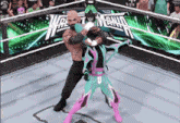 two wrestlers are fighting in a ring with a sign that says world heavyweight championship