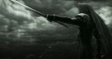 a black and white photo of a person holding a sword .