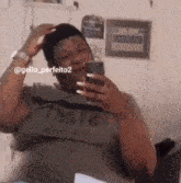 a man is taking a picture of himself in a mirror while holding a cell phone .