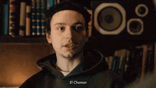 a man wearing a black hoodie with el chaman written on it