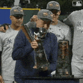 a man holding a trophy that says ' american league world series ' on it