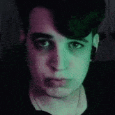 a close up of a person 's face with purple and green lights
