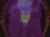 a purple and gold mirror with a green face behind it