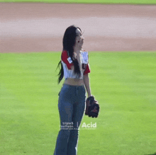 a girl in a seoul shirt is kneeling on the grass