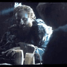 a man with a beard is sitting at a table