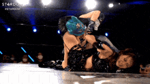 two women wrestling in a ring with the word stardom on the bottom right