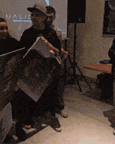 a man holding a book that says dualidad