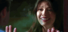 a woman is smiling and looking at a man