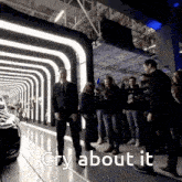 a group of people standing in front of a car with the words cry about it written below them