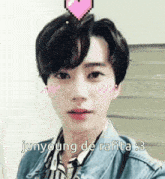 a young man with a pink heart in his hair and the words junyoung de rafita written below him