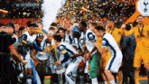 a group of soccer players are posing for a picture with the trophy