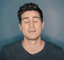 a man with his eyes closed is wearing a black shirt