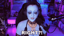 a woman with blue paint on her face is sitting in front of a microphone and says " right ? "