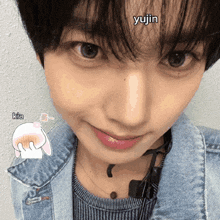 a close up of a woman 's face with the name yujin written on her forehead