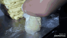 a person is putting something in a plastic bag that says made in animatica on the bottom