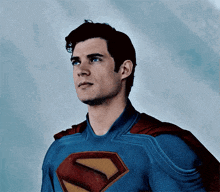 a close up of a man in a superman costume looking up .