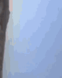 a person 's hand is pointing at something in the sky
