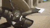 a black robot is flying through the air while holding a piece of paper in its hand .