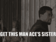 a man is standing in front of a group of people with the words `` get this man ace 's sister '' .