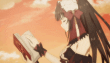 a girl is reading a book with a red cover