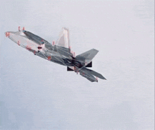 a fighter jet is flying through a cloudy sky with a smoke trail behind it and a few numbers on the ground