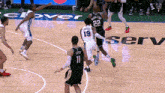 a basketball game is being played in front of a banner that says serv