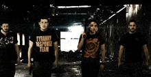 a man wearing a shirt that says tyranny response team walks with two other men