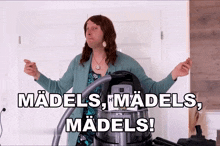 a woman standing next to a vacuum cleaner with the words " madels madels madels " written above her