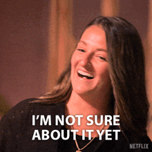 a woman laughing with the words i 'm not sure about it yet