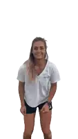a woman in a white shirt and black shorts with the word adidas on the shorts