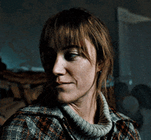 a close up of a woman wearing a sweater