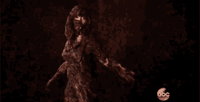 a woman is dancing in a dark room with the abc logo in the background