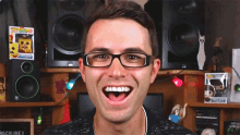 a man wearing glasses is making a funny face in front of a sign that says " scribe i "