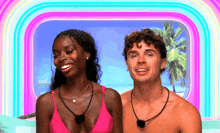 a man and a woman are standing next to each other on a beach