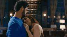 a man and a woman are looking at each other in a room