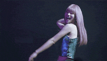 a woman is dancing on a stage with a green background .