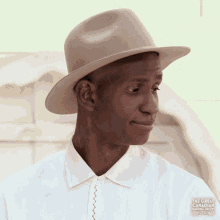 a man wearing a hat and a white shirt with the words the great canadian baking show below him