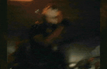 a group of people are dancing in a dark room with a fire in the background