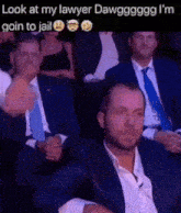 a man in a suit and tie is pointing at another man in a suit and tie ..