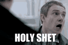 a man with a surprised look on his face and the words `` holy shet '' written on his face .