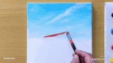 a person is painting a picture of a blue sky with a red brush