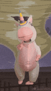 a person in an inflatable unicorn costume is dancing