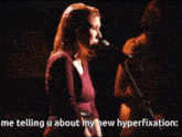 a woman singing into a microphone with the words me telling u about my new hyperfixation below her