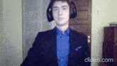 a man wearing headphones and a blue shirt is shown on clideo
