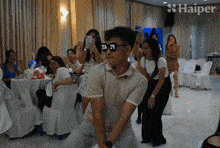a group of people are dancing in front of haiper
