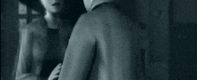a black and white photo of a person in a suit and tie .