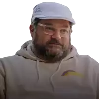 a man with a beard and glasses wearing a hat